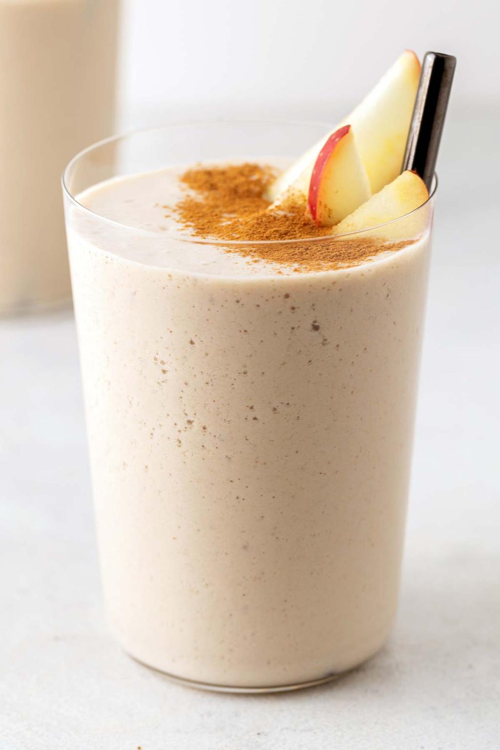 Apple cinnamon smoothie made with apple, banana, oats, and yogurt in a glass