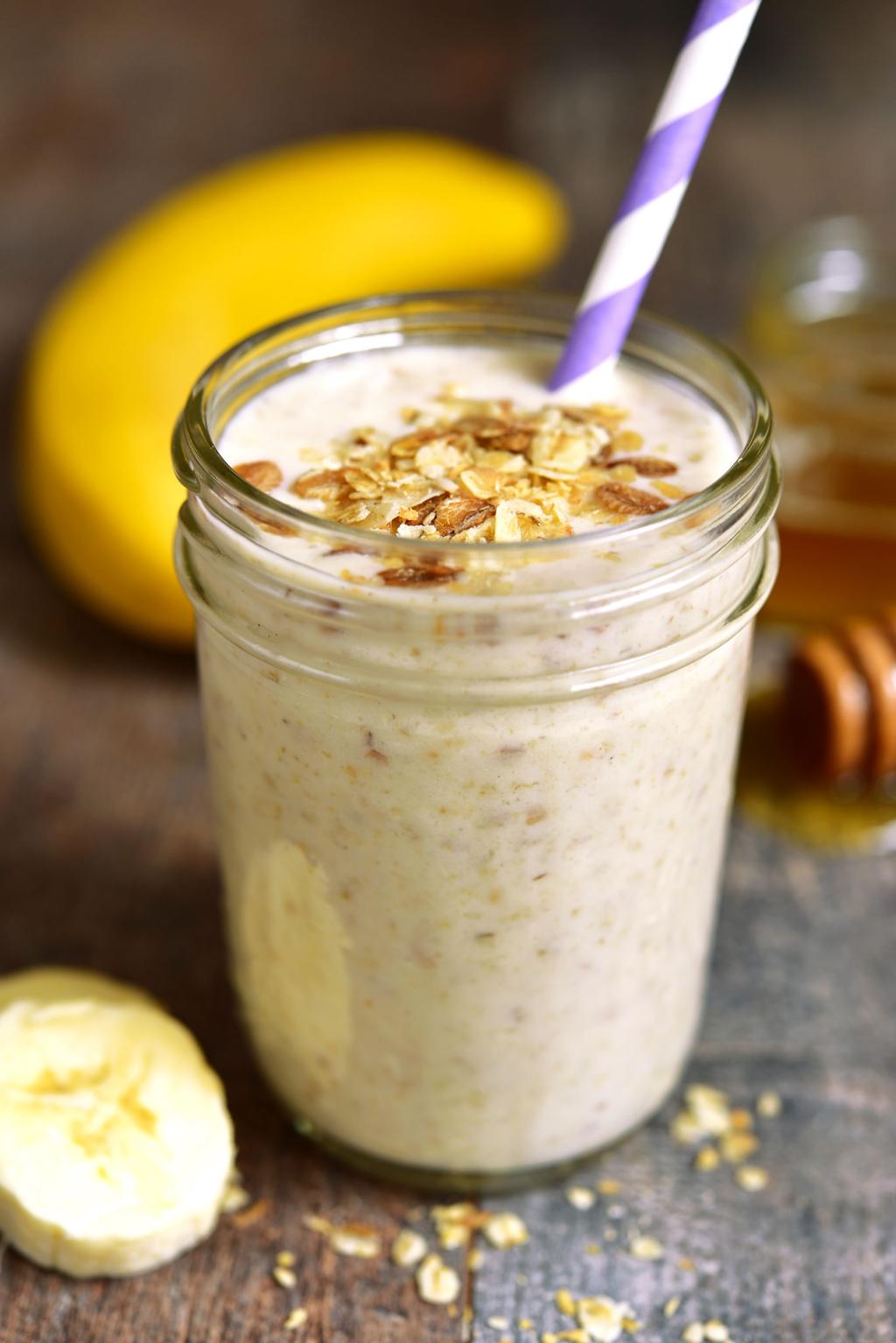 Thick banana oat breakfast smoothie with oats, banana, milk, and cinnamon served in a glass"