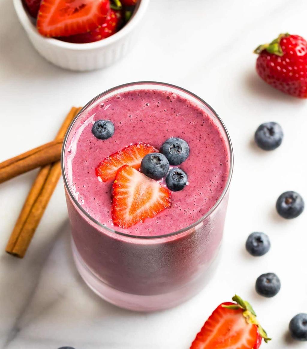 Creamy berry protein smoothie with mixed berries, yogurt, and protein powder in a glass